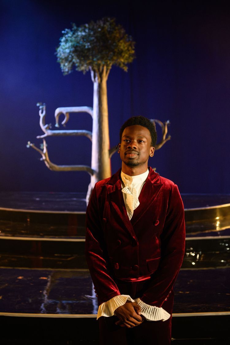 Scene from Orlando - actor standing in front of tree
